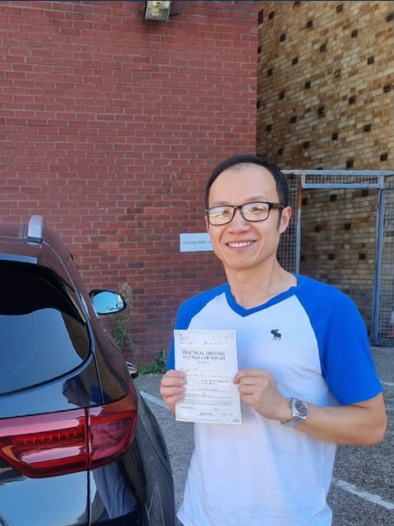 Client showing his pass certificate after the driving exam
